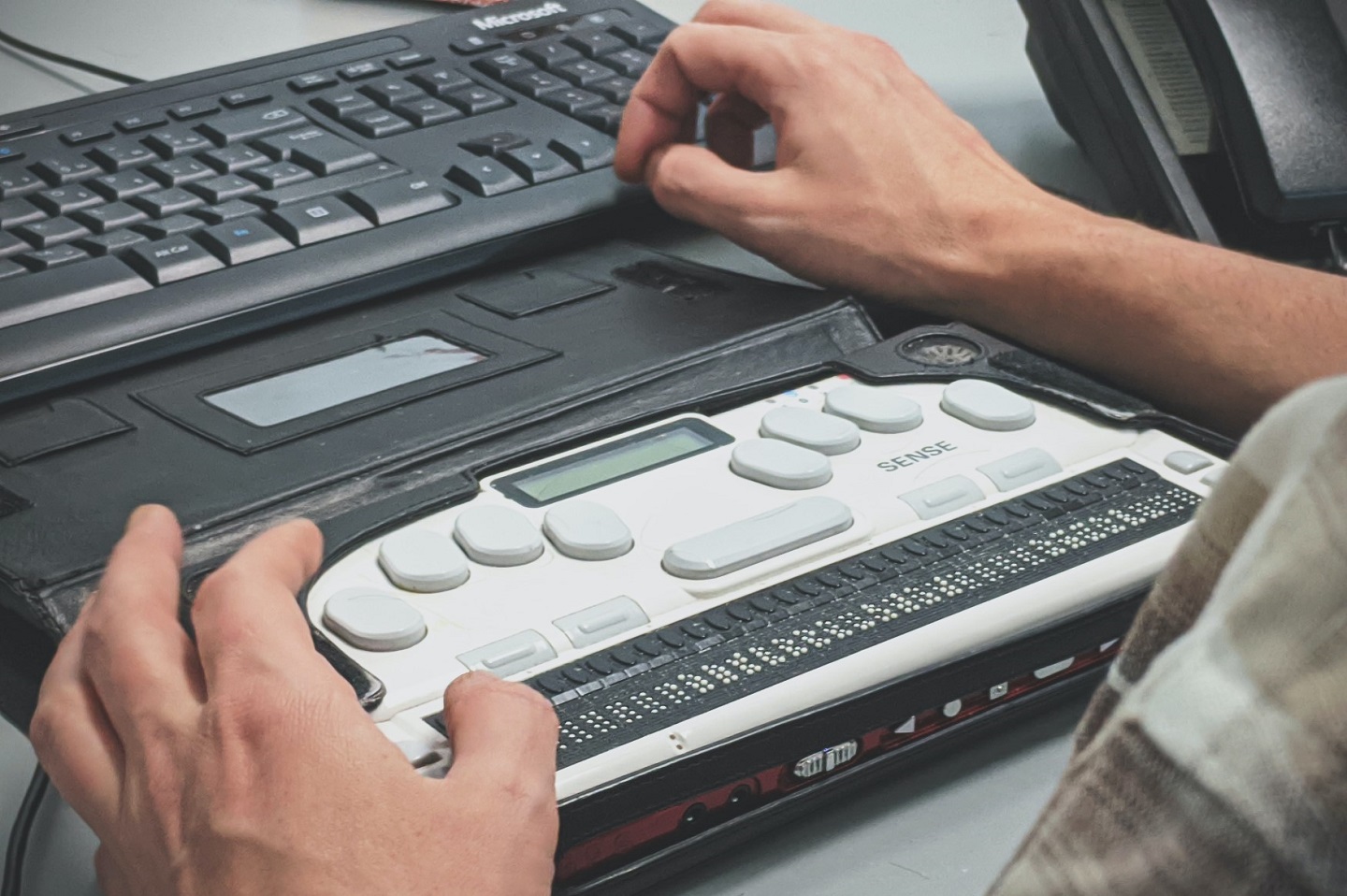 Hands over an accessible keyboard.